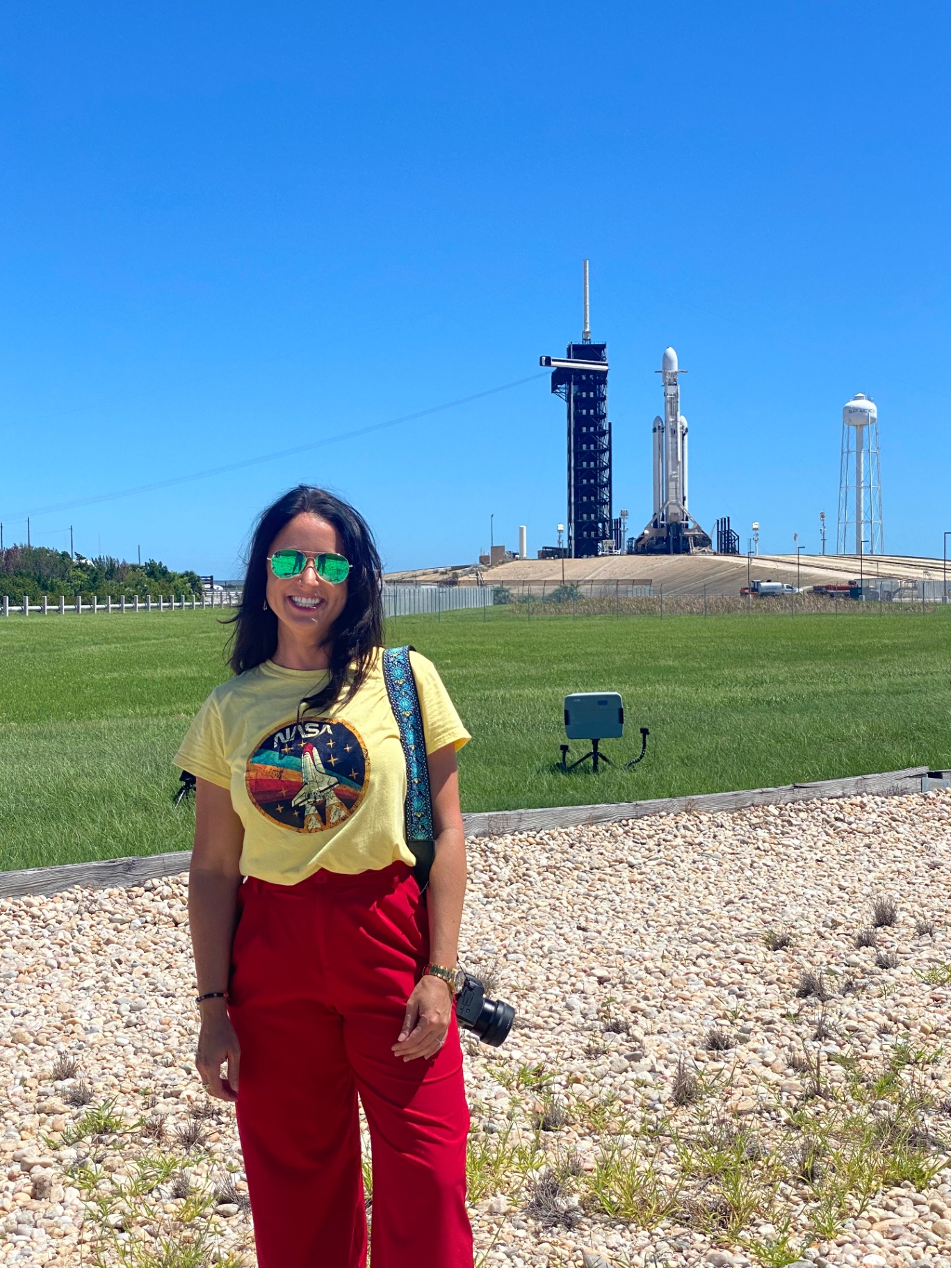 Blythe in front of a SpaceX Falcon Heavy rocket on the launch pad